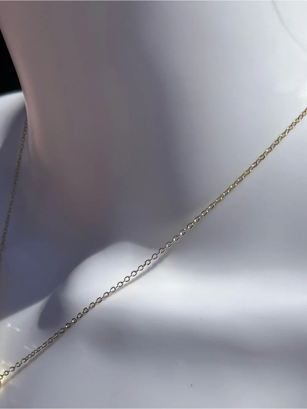 Elegant gold-tone pendant necklace featuring a pavé double ring design. NWT.